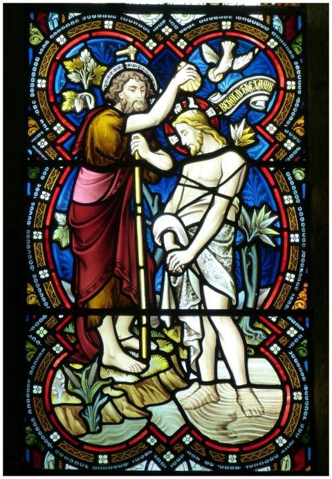 Detailed stained glass window depicting a religiou