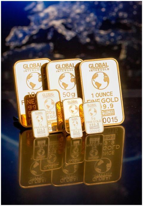 Collection of gold bars featuring a global map and