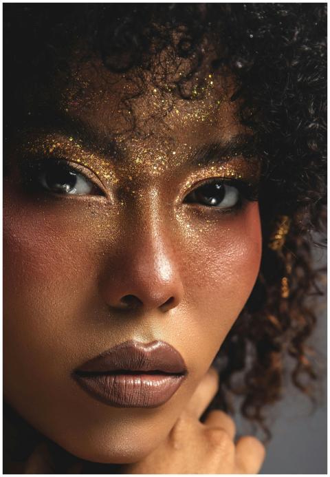 Stunning close-up of a woman with glittery makeup