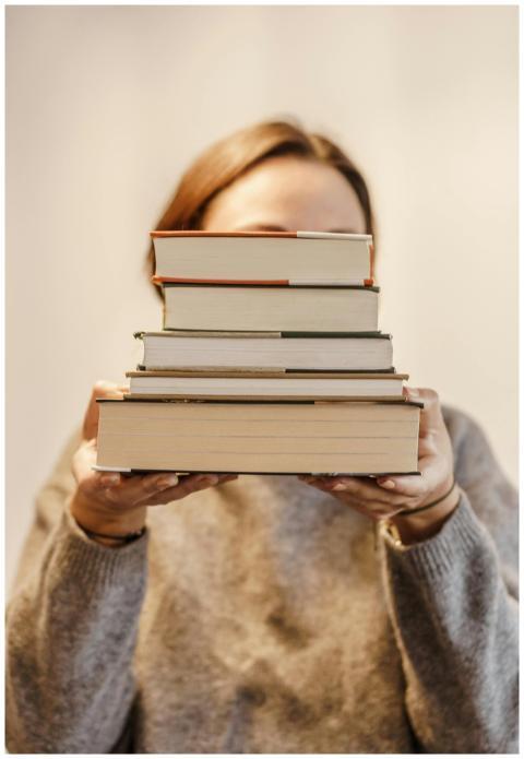 Anonymous woman in soft sweater covering face with