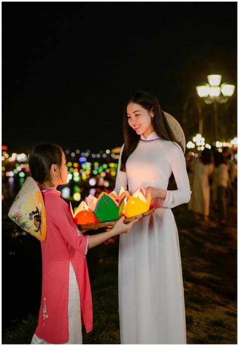 A woman and child share colorful lanterns during H