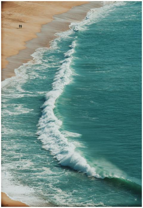 A scenic aerial view of turquoise waves crashing o
