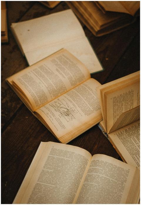 A collection of vintage open books with yellowing
