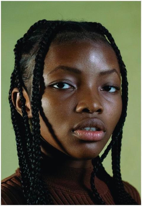 Close-up portrait of an adult woman with braided h