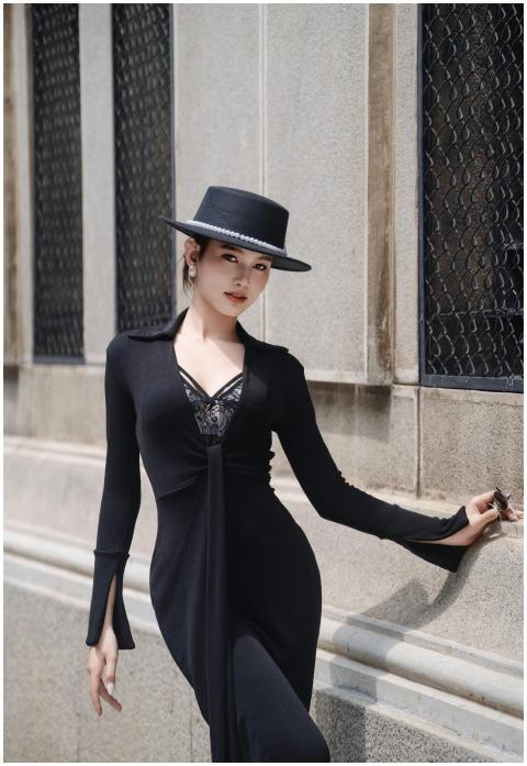 Stylish woman in black dress and hat leaning again