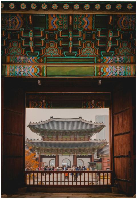 A beautifully ornate gate framing a historical Asi