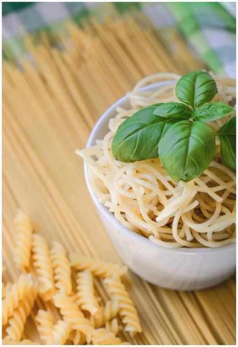 Bowl of freshly cooked spaghetti topped with basil