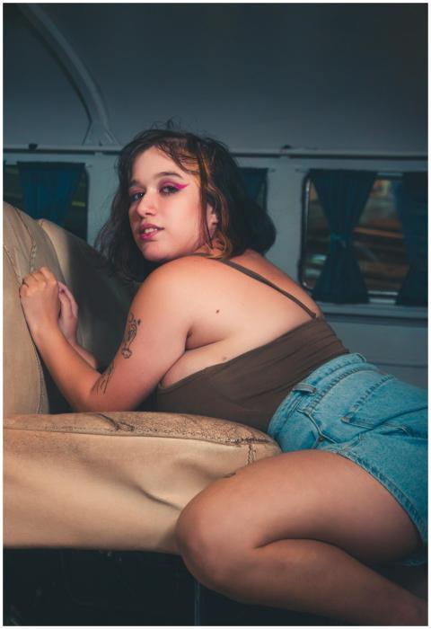 Fashionable woman posing inside a vehicle, conveyi