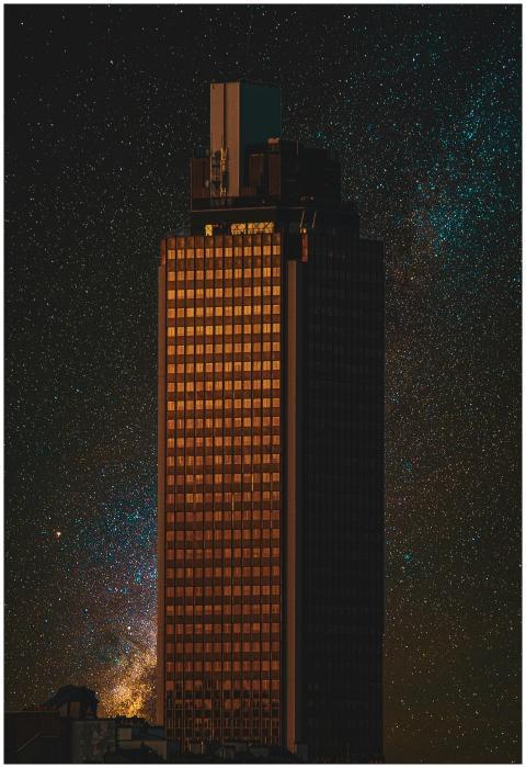 A high-rise building stands illuminated against a