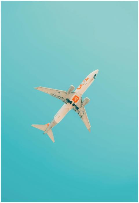 A commercial airplane flies above São Paulo with a