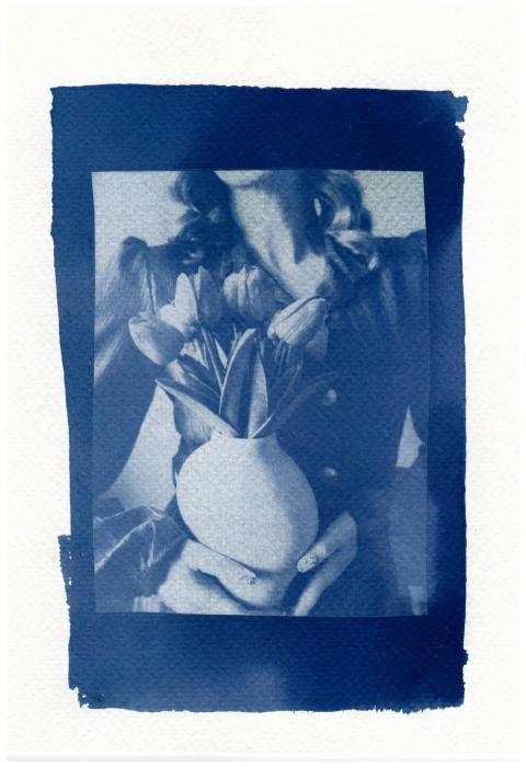 Artistic cyanotype print of a woman holding tulips