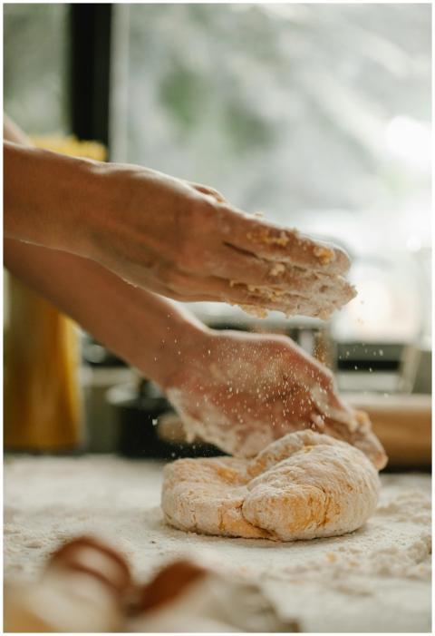 Unrecognizable woman kneading fresh and soft egg d