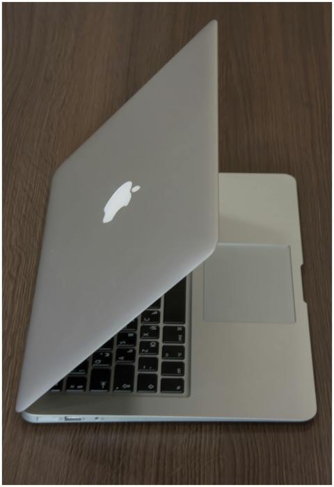 An angled view of a sleek laptop on a wooden table