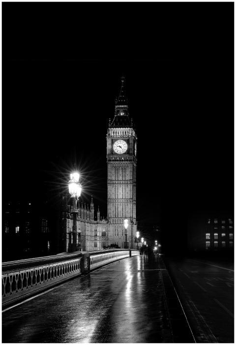Black and white photo of Big Ben illuminated at ni