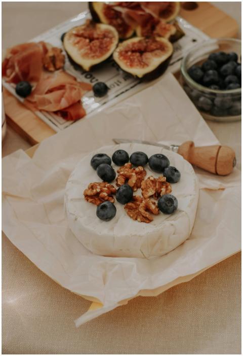 A gourmet arrangement of brie cheese topped with b