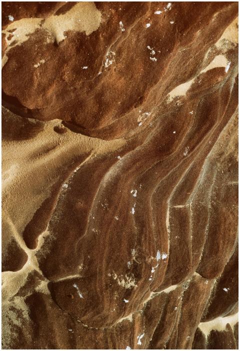 Close-up of textured sandstone patterns with earth