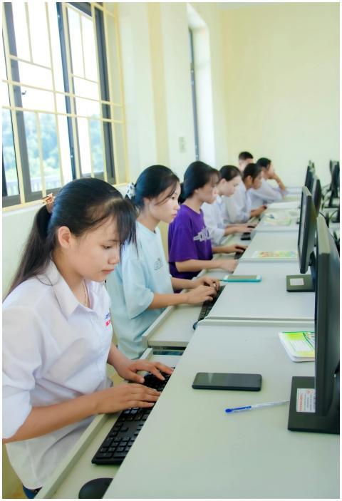 Young students engaged in a computer lab, focused