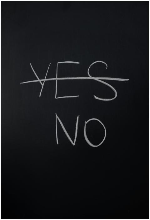 Handwritten chalk decision concept with 'yes' cros