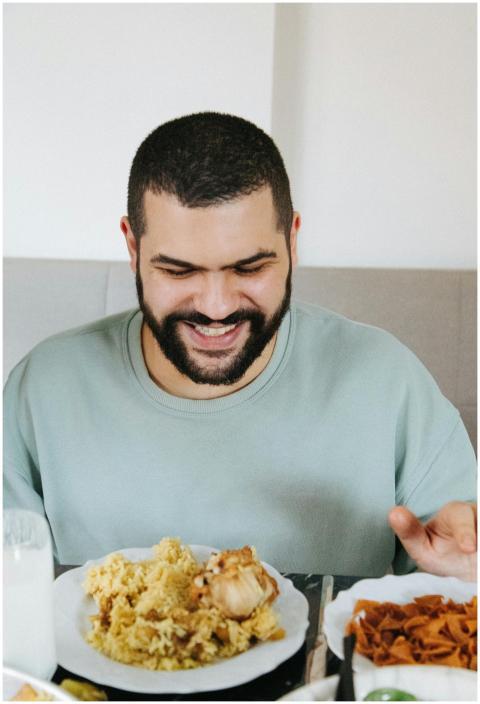 A happy man indulging in a delicious plate of Maql