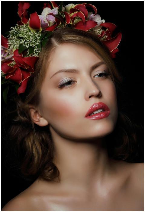 Close-up portrait of a woman with a bold floral cr