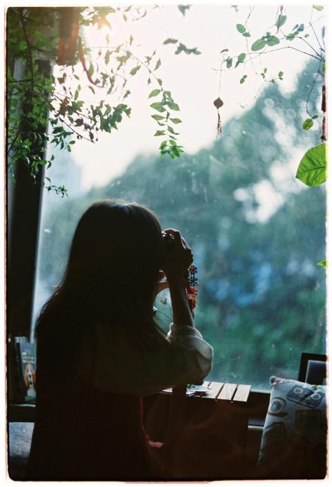 A woman with a camera appreciates the serene morni