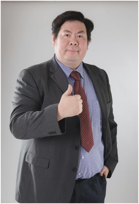 Mature Asian businessman in a suit with a thumbs-u