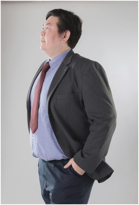 Portrait of a man in a suit with a red tie, lookin