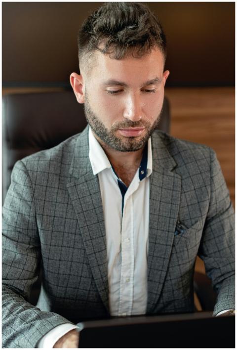 Businessman in a gray suit focused on work at an o