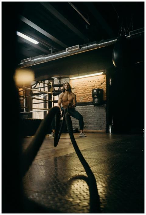 A muscular man showcases strength and endurance du