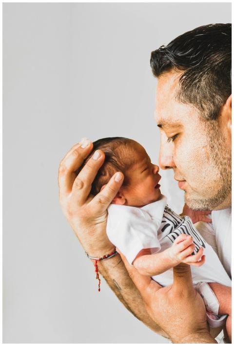 A touching portrait of a father gently holding his