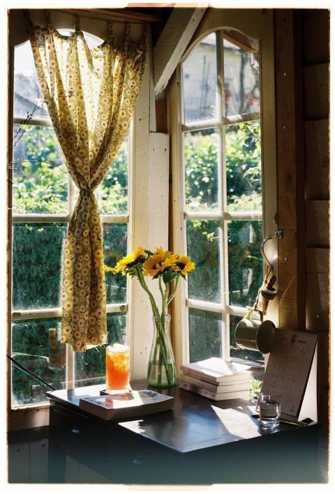 A bright and cozy window nook featuring sunflowers