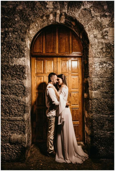 An intimate moment between a bride and groom embra