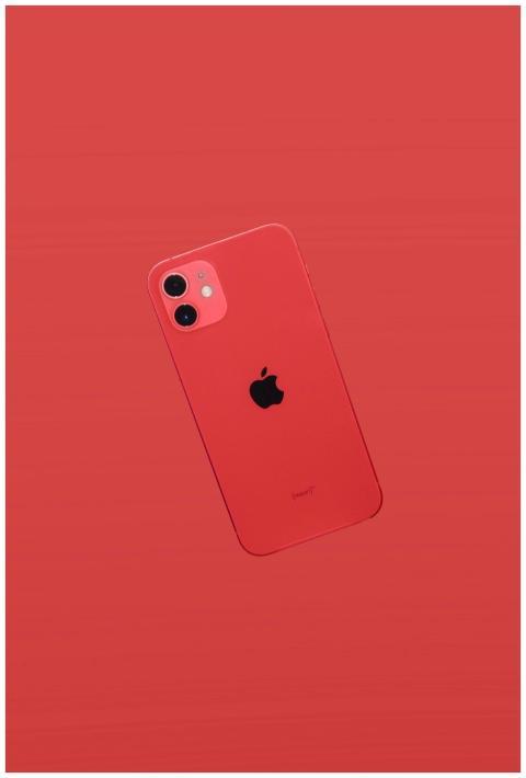 Red smartphone on a matching red background showca
