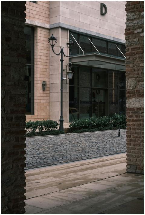 A quiet urban scene with cobblestone street and vi