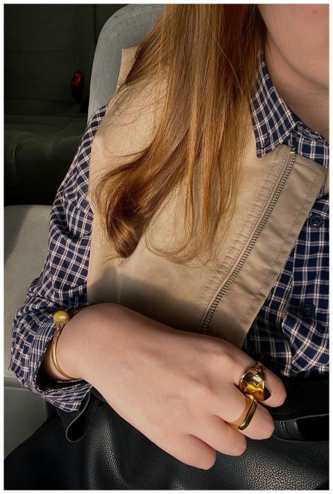 Woman displaying casual style with plaid shirt and