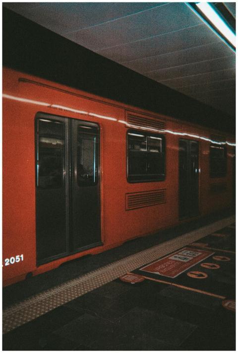 Orange subway train at a station in Mexico City, h