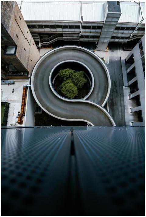 High-angle view of a spiral road surrounded by urb