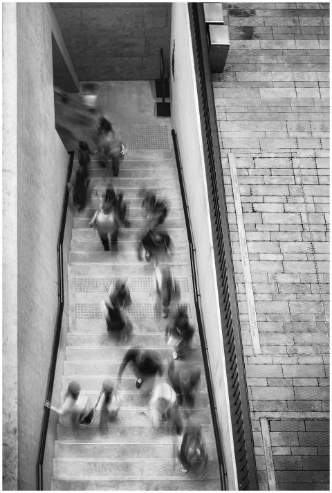 Blurred black and white capture of people moving o