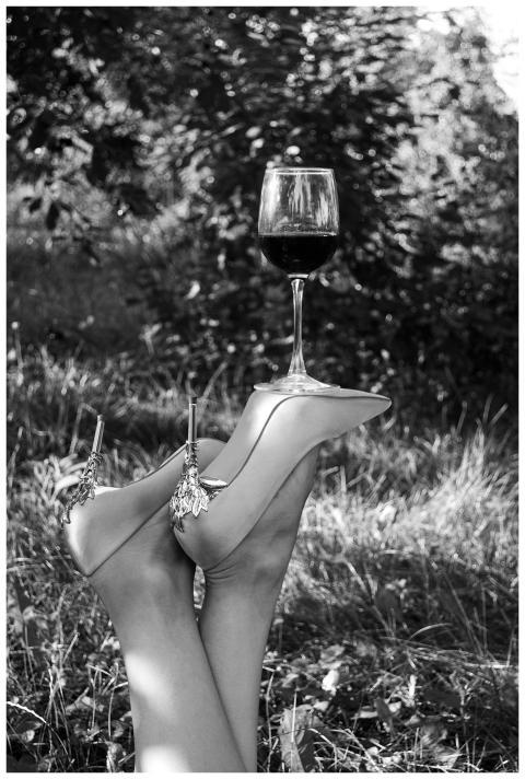 Black and white photo of stilettos balancing a win