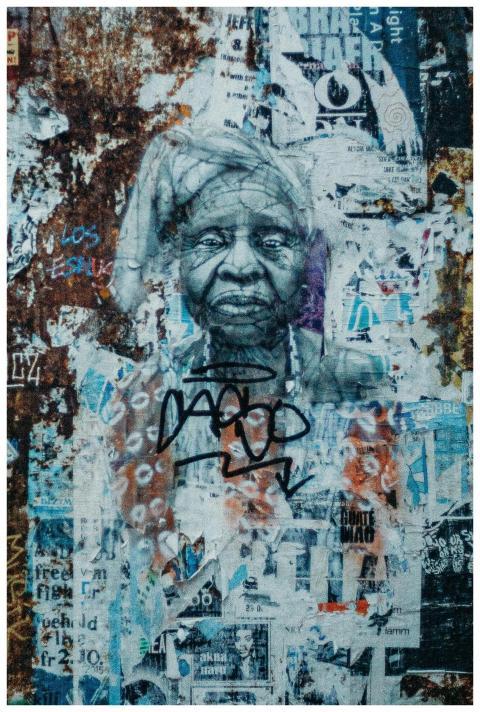 Creative street art mural of an elderly woman on a