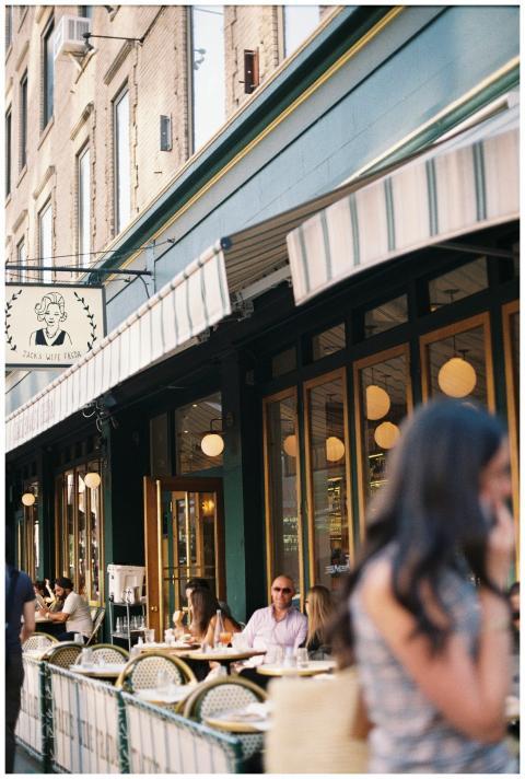 Outdoor city cafe with people dining and enjoying