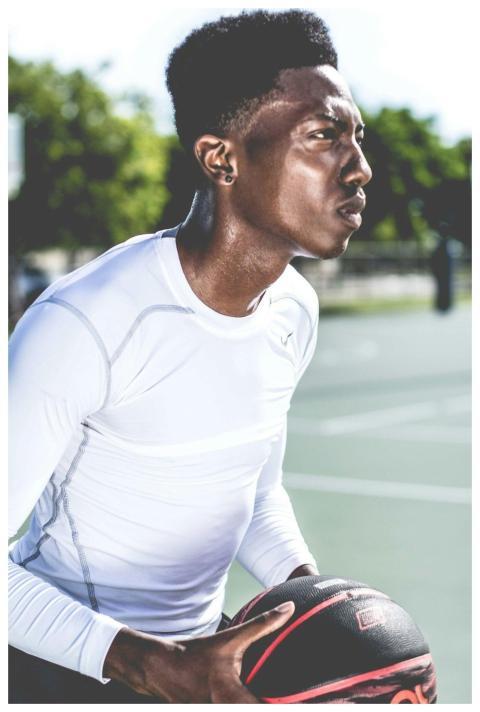 Intense moment of a basketball player outdoors, ca