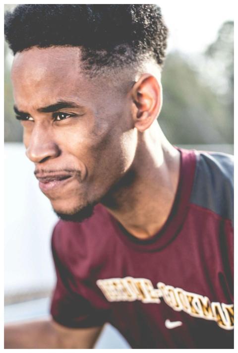 Portrait of a determined young athlete in maroon s