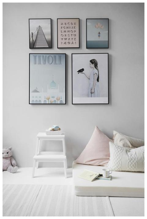 Minimalist Scandinavian bedroom with wall art and