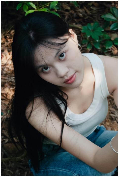 Portrait of a young woman in a natural setting, su