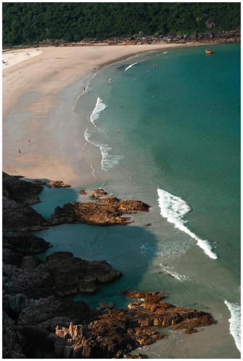 An aerial view of a serene beach with turquoise wa
