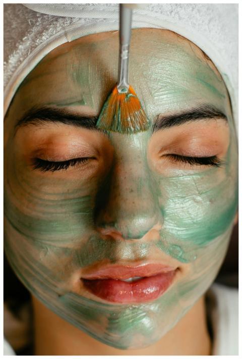 Close-up of a woman enjoying a green cosmetic faci