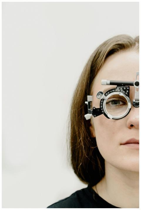 Close-up of woman wearing phoropter for vision tes