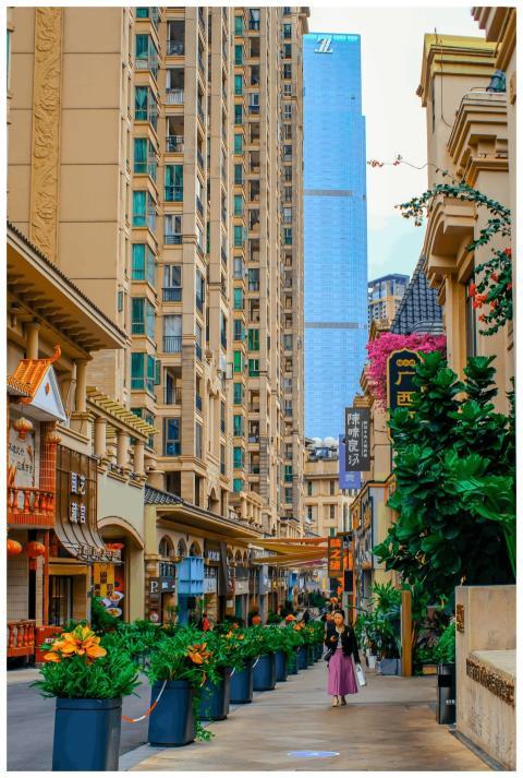 Bustling alleyway with greenery and shops in a mod