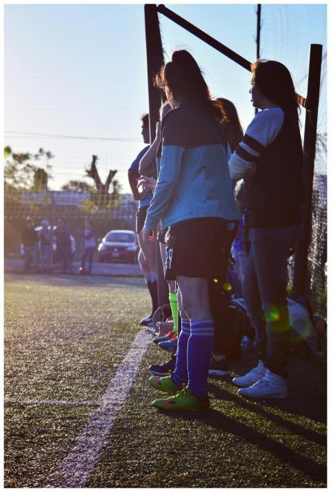 Group of women soccer players standing on the fiel